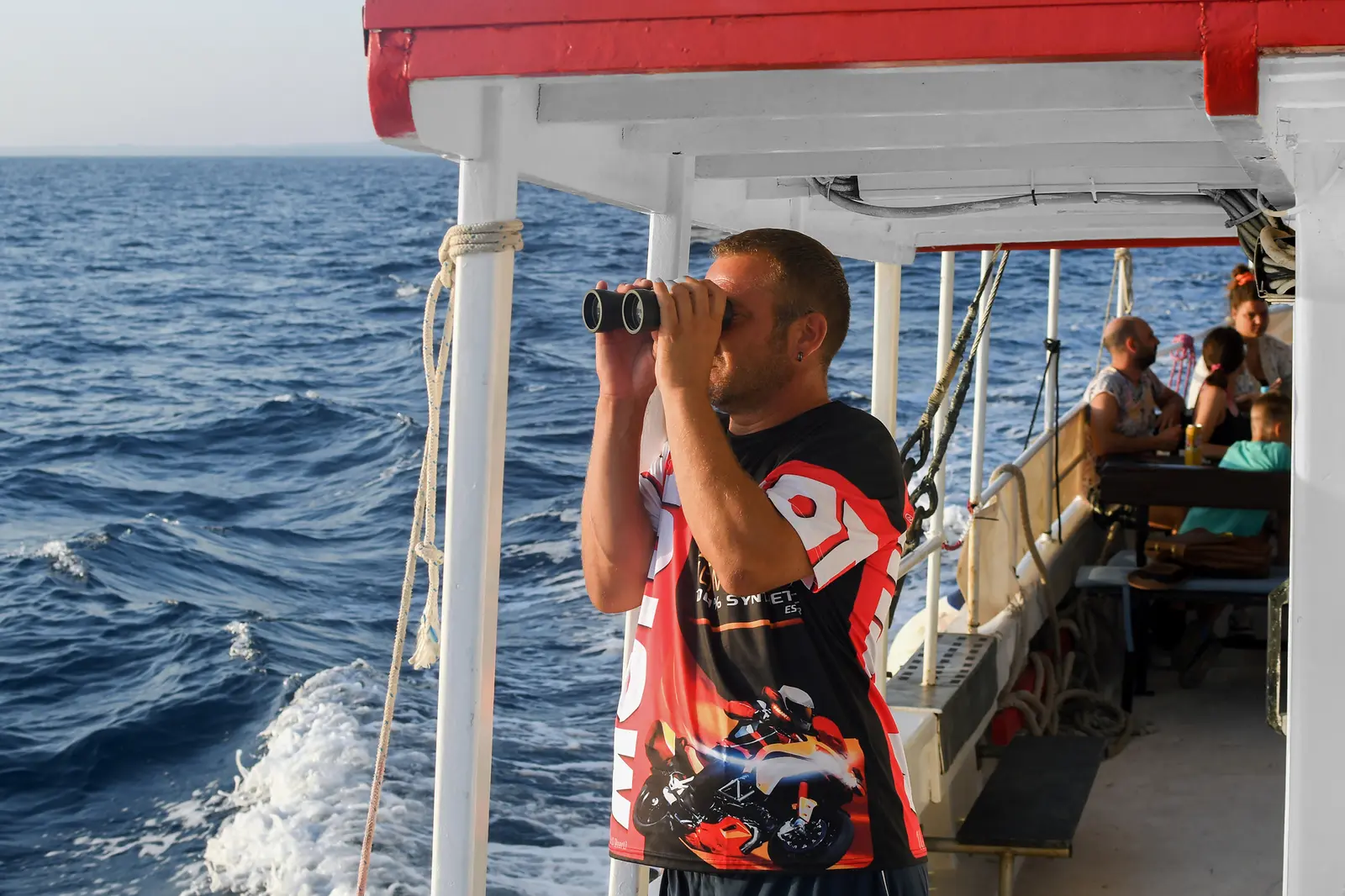 Captain scanning the Adriatic for dolphins